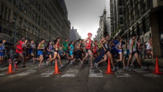 A photo of several marathon runners running from left to right across the frame.