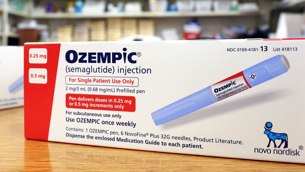 A photograph of a box of Ozempic on a pharmacy counter