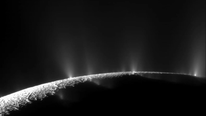 A photo of jets of water vapor erupting on the surface of Enceladus.